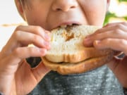 Kids Digestive Problems: child eating sandwich
