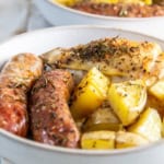 plate of oven chicken bake with potatoes and sausage