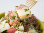 one piece of warm red potato salad recipe on a fork