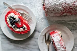 red, white and blue dessert gluten-free cake roll dusted with powdered sugar