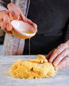 adding oil to kneading fresh gluten-free pasta dough