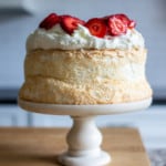 gluten-free angel food cake recipe topped with strawberries and cream