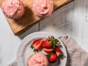 gluten free strawberry cupcakes with strawberry frosting and fresh berries