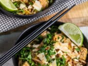 two bowls of pad thai on light background