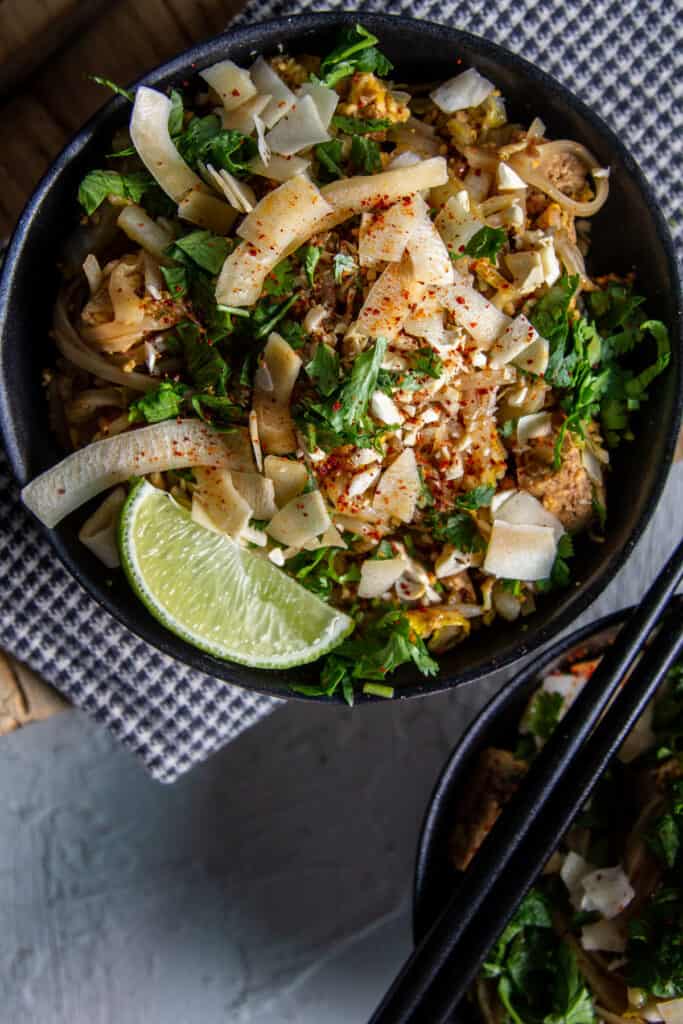  a bowl of pad thai on light background