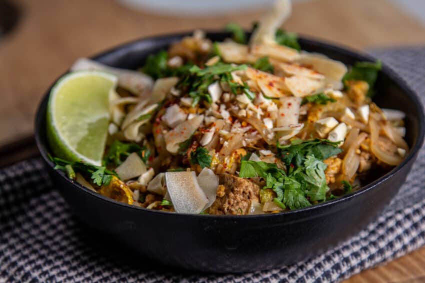 a bowl of pad thai on light background