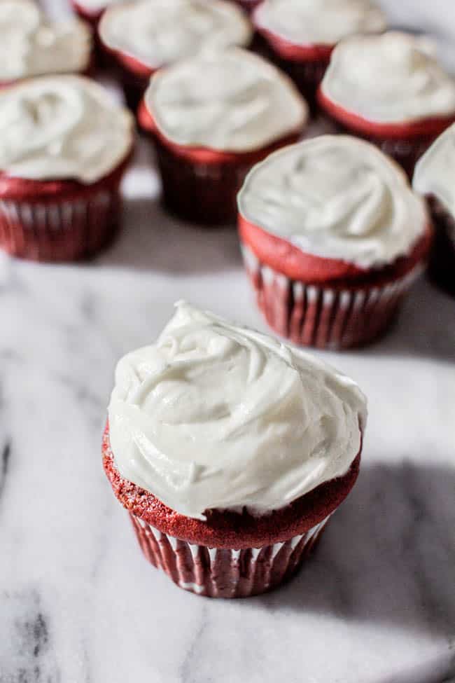 A batch of red velvet cupcakes on marble background