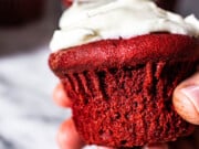 hand holding red velvet cupcake