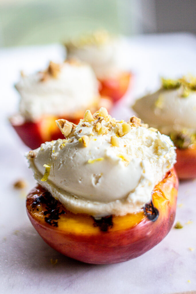 4 grilled nectarines with mascarpone filling on marble background