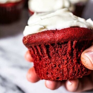 hand holding red velvet cupcake