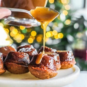Pouring toffee syrup on sticky toffee puddings