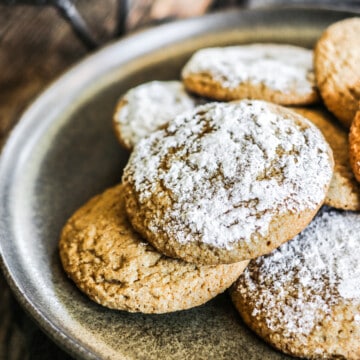 Plate of ginger molasses cookies on dark background