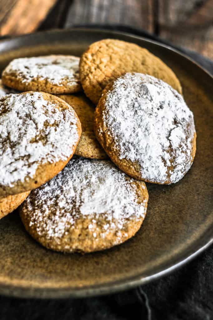 Plate of ginger molasses cookies on dark background