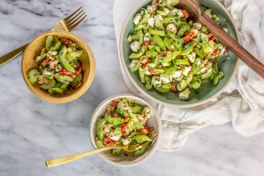 celery in salad bowls with mozzarella, walnuts and peppers