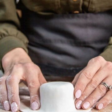 hand forming fondant to cake