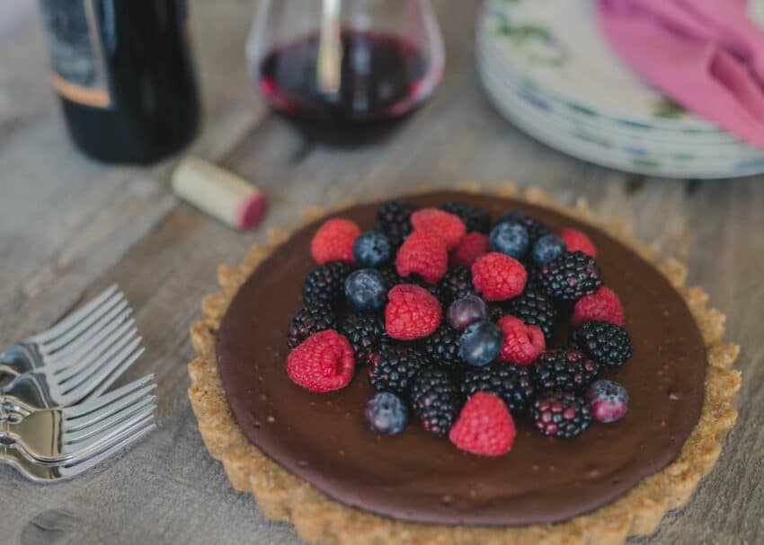 dark chocolate tart with raspberries, blackberries and blueberries