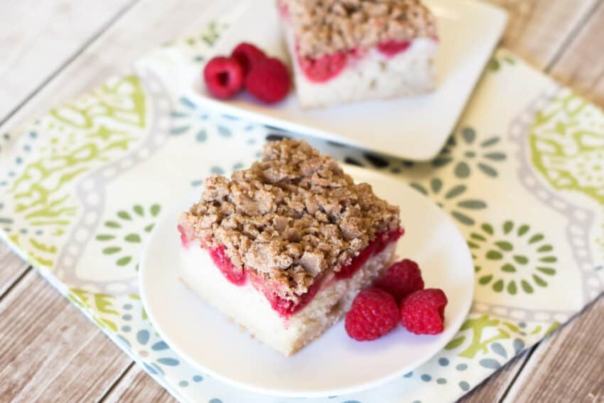 raspberry vegan coffee cake slice with berries on plate
