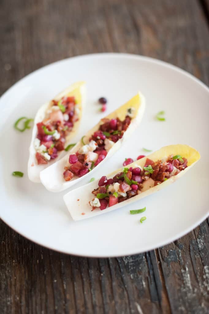 endive cups appetizer recipe on a white plate