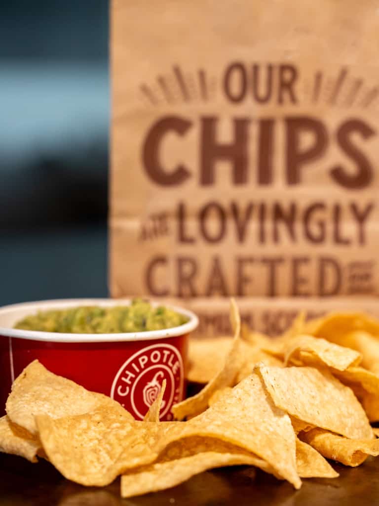 Chipotle chips with a bag that reads "our chips are lovingly crafted for maximum scoop age
