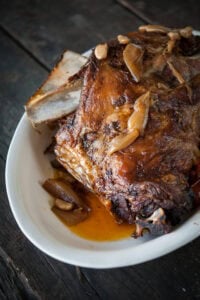 whole roasted bone in lab shoulder roast on platter