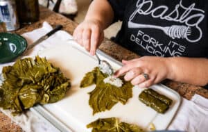 rolling a grape leaf with rice filling