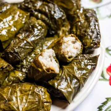 plate of stuffed grape leaves with rice, one cut open
