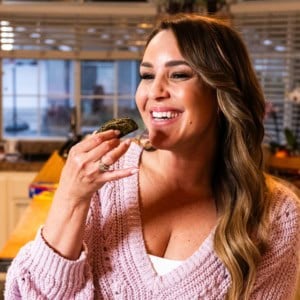 woman eating a stuffed grape leaf